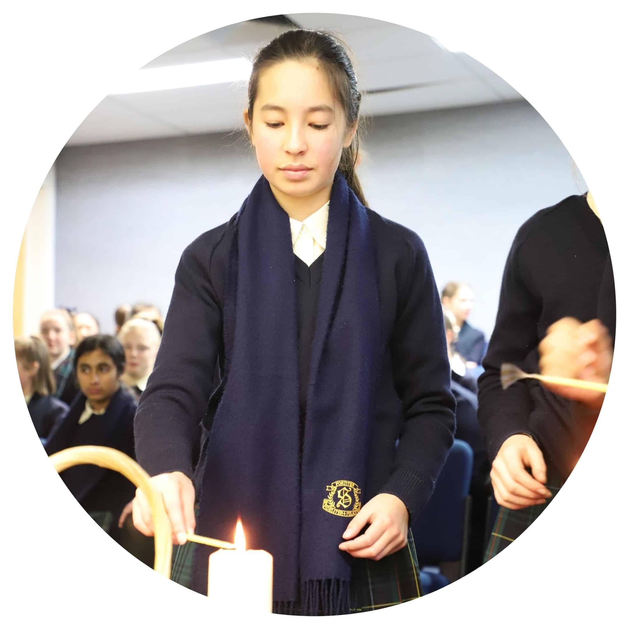 student lighting candle